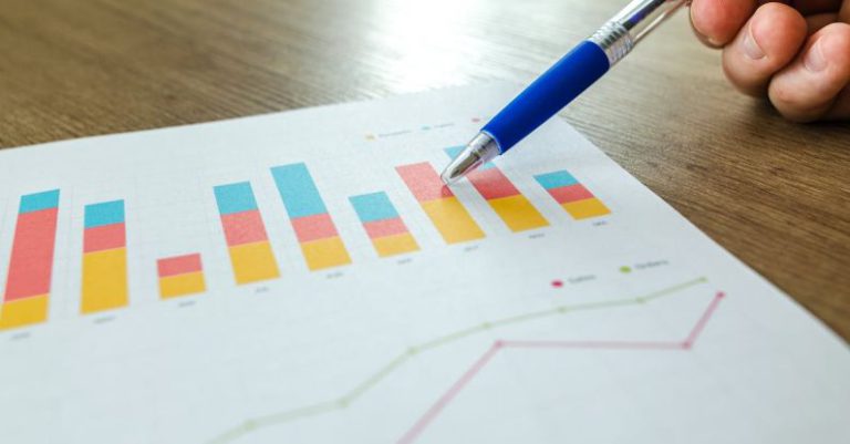 Metrics - Person Holding Pen Pointing at Graph