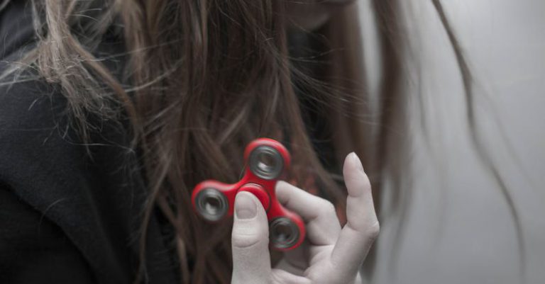 Trends - Woman Holding Red Hand Spinner