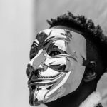 Campaigns - Black activist wearing Anonymous mask as sign of protest