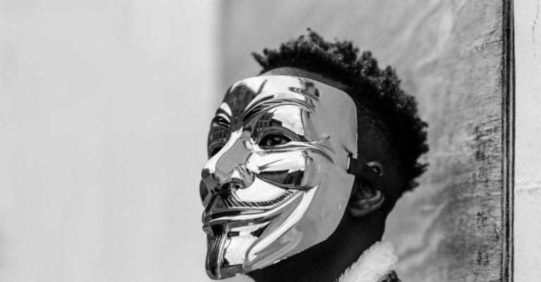 Campaigns - Black activist wearing Anonymous mask as sign of protest