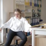 Behavior - Bossy female employee in formal wear sitting on chair in workplace and demonstrating frivolous and unprofessional behavior while looking away