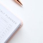 Calendar - Close-Up Photo of Yearly Planner Beside a Pen