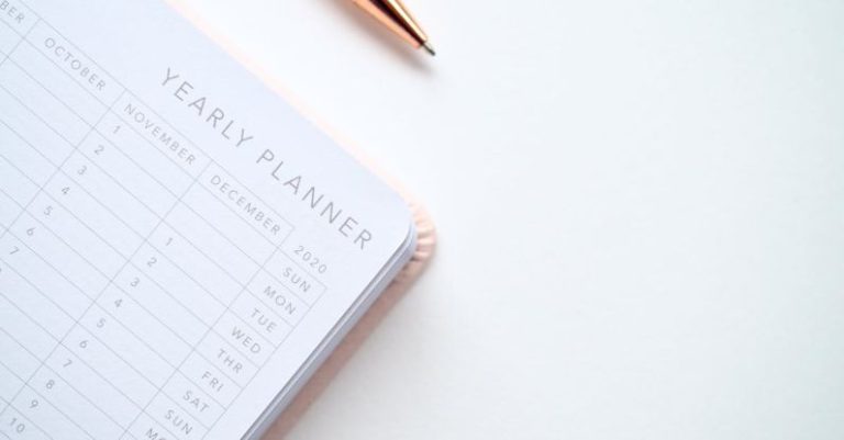 Calendar - Close-Up Photo of Yearly Planner Beside a Pen